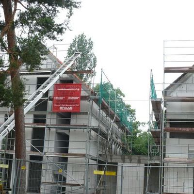 Die Wohnanlage bei der Erstbegehung im Juni 2012. Die moderne Architektur von Peter Faust, Architekt in Mainz, tritt ehrfürchtig vor den bizarr gewachsenen Kiefern zurück. Lange schmale Fensterstreifen korrespondieren zu den aufstrebenden Kiefernstämmen.